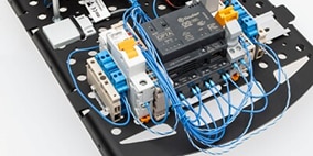 A close up view of the Arduino Opta PLC on a circuit trainer