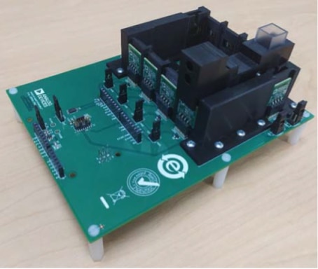 Fully assembled Analog Device EVAL-CN503-ARDZ on top of the EVAL-AIDCUP3029 Image of fully assembled Analog Device EVAL-CN503-ARDZ on top of the EVAL-AIDCUP3029