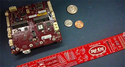 VersaLogic’s Raven EPU Next to a Ruler and U.S. Coins for Size Comparison