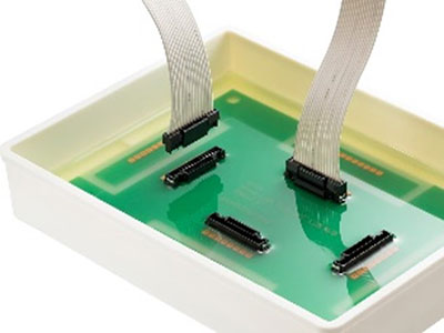 A transparent potting compound covers the entire PCB and the back side of the connectors fighting back against the harsh elements