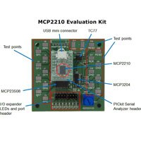 Image of an MCP2210 evaluation kit board with components labeled MCP2210 Evaluation Kit
