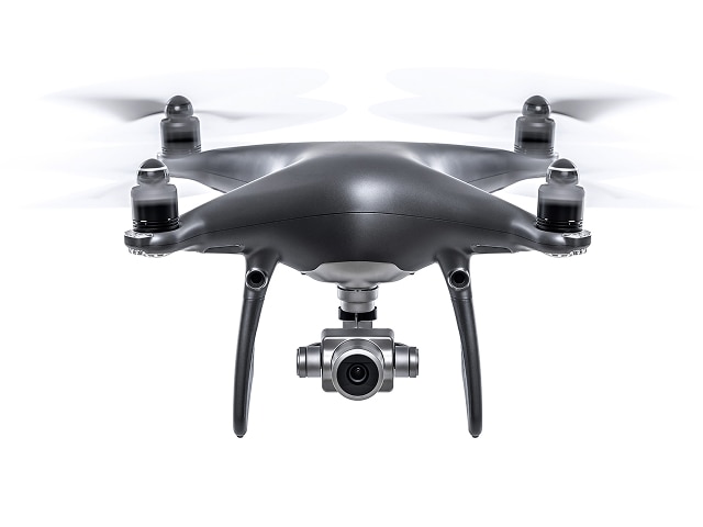 Head on photograph of a quadcopter drone on a white background