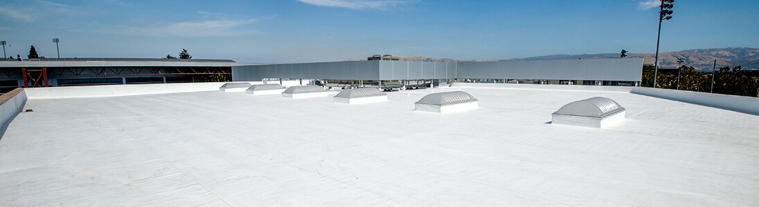 A large commercial roof painted white to reflect sunlight