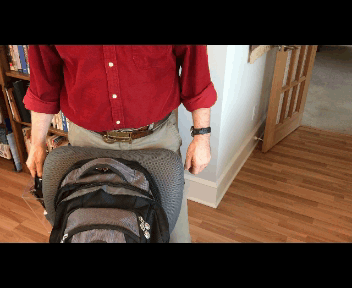 Man Placing Kit in Backpack