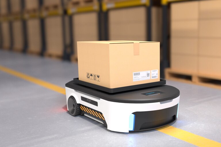 An autonomous mobile robot shuttling a package through a warehouse