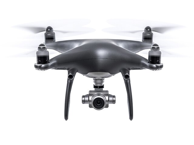 Head on photograph of a quadcopter drone on a white background